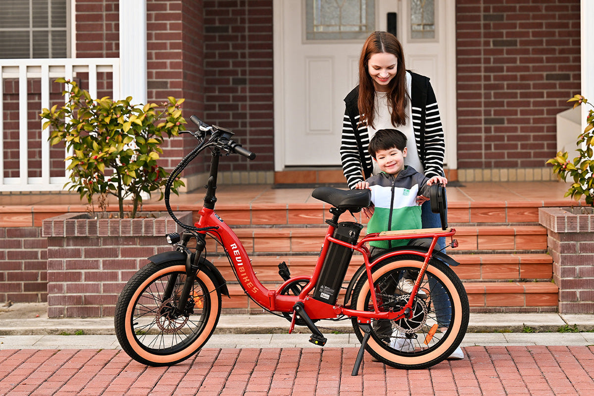 Parent and child with a red ROOTS RIDER Rebel 2 folding electric bike outside a house