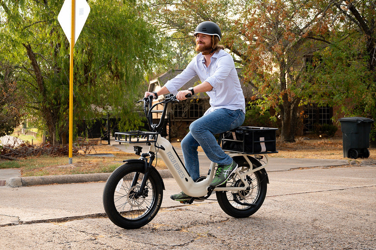 Commuter riding a ROOTS RIDER Runabout 2 step-through electric bike on a city street